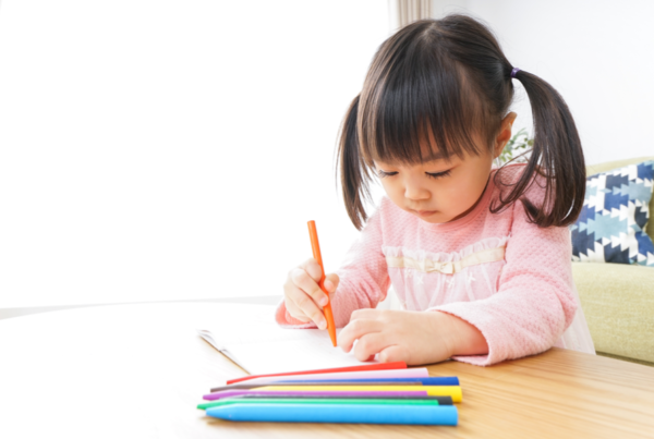 Child drawing with crayons