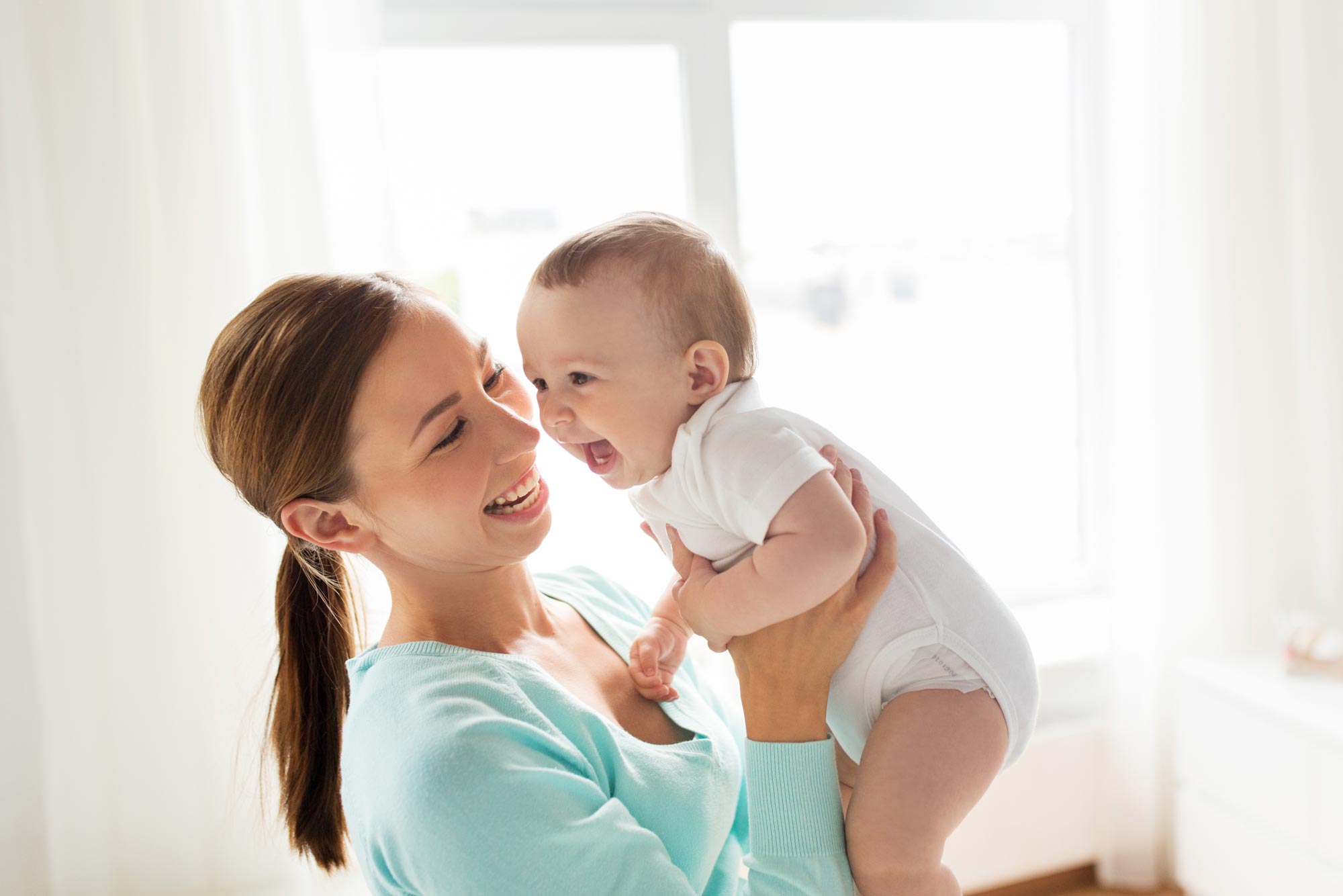 Mom holding laughing baby