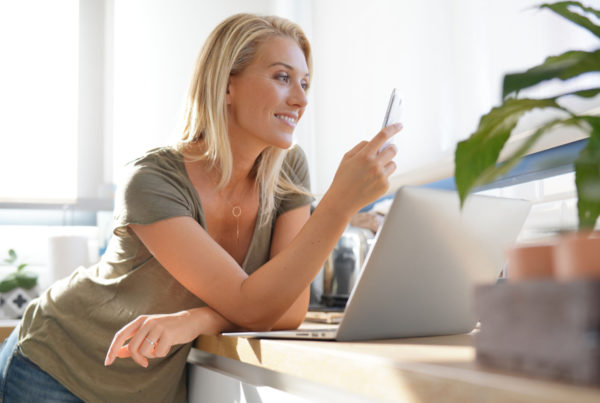 Mom using social media on phone and computer