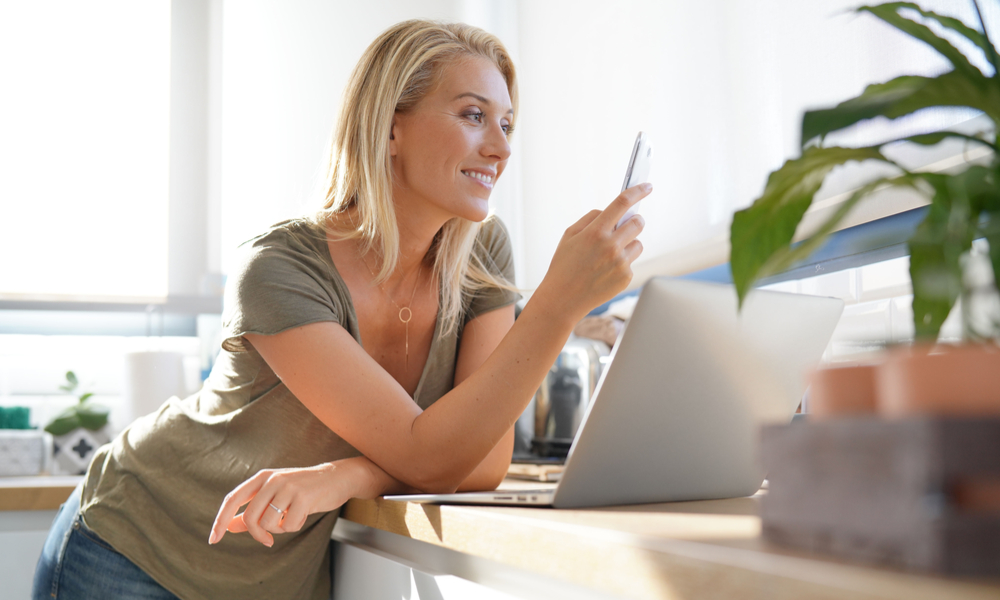 Mom using social media on phone and computer