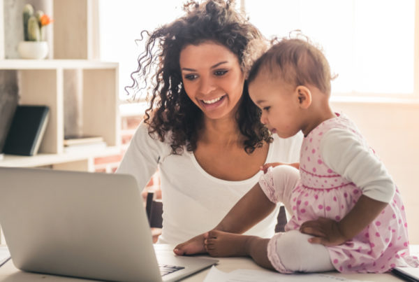 Mom and daughter looking at laptop together