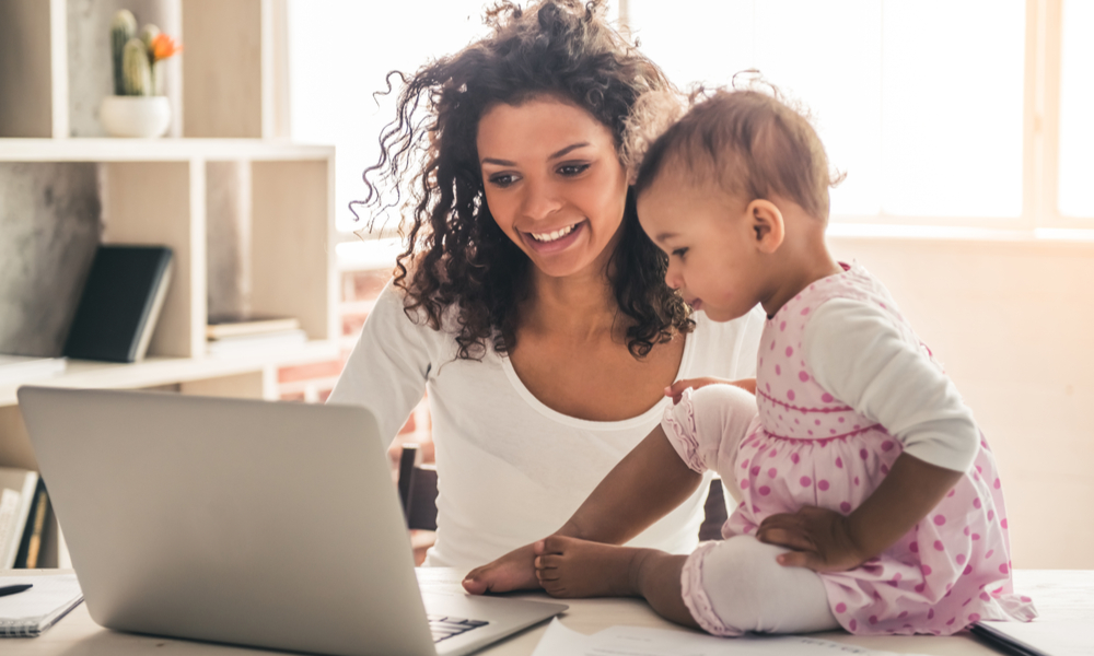 Mom and daughter looking at laptop together