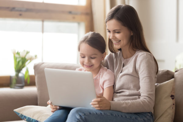 Mom and daughter looking at laptop together