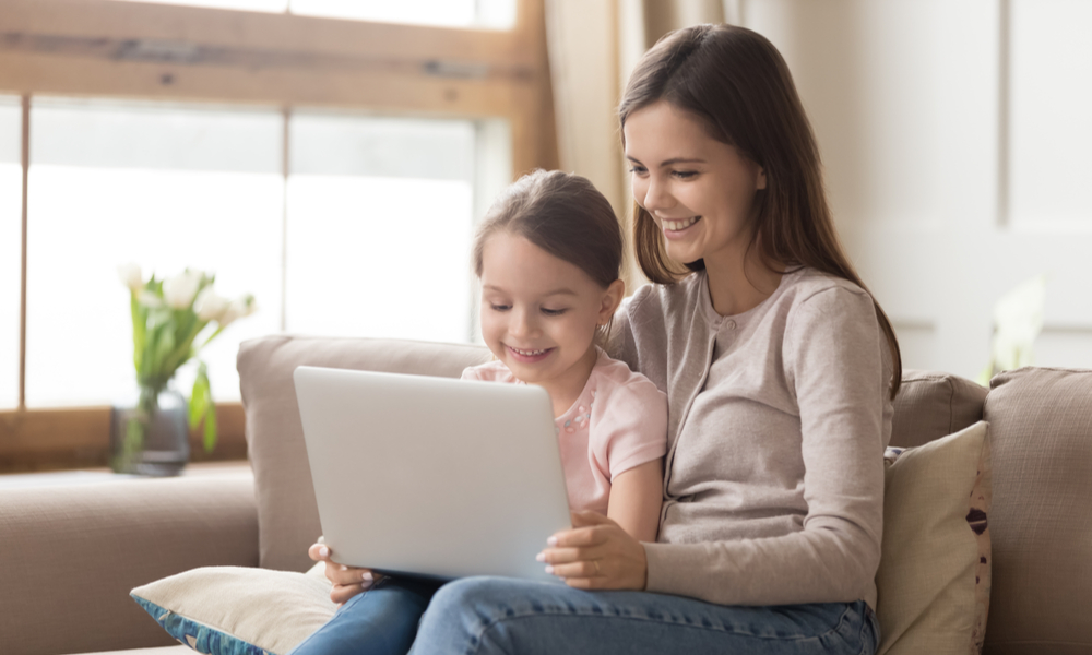 Mom and daughter looking at laptop together