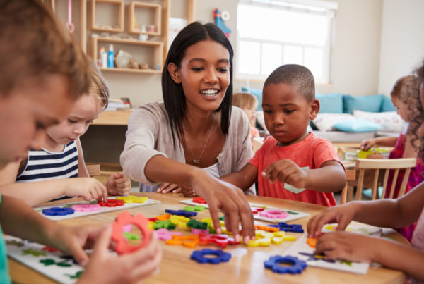 Preschool teacher with students in classroom