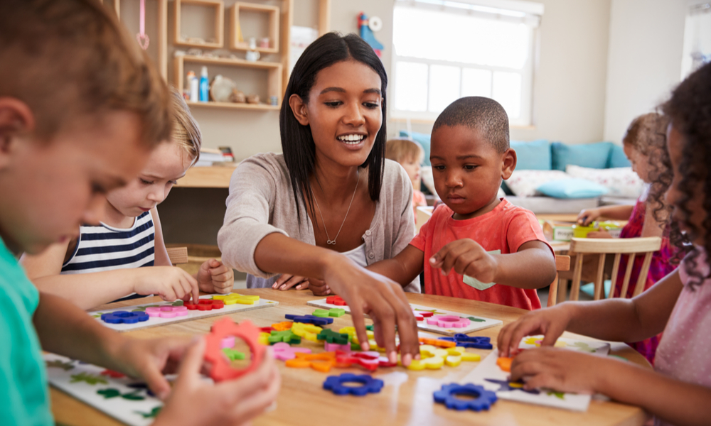 Preschool teacher with students in classroom