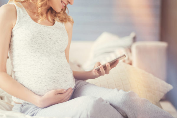Pregnant mother using smartphone to research child care