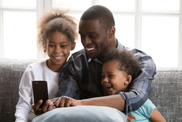 Father taking selfie with two children