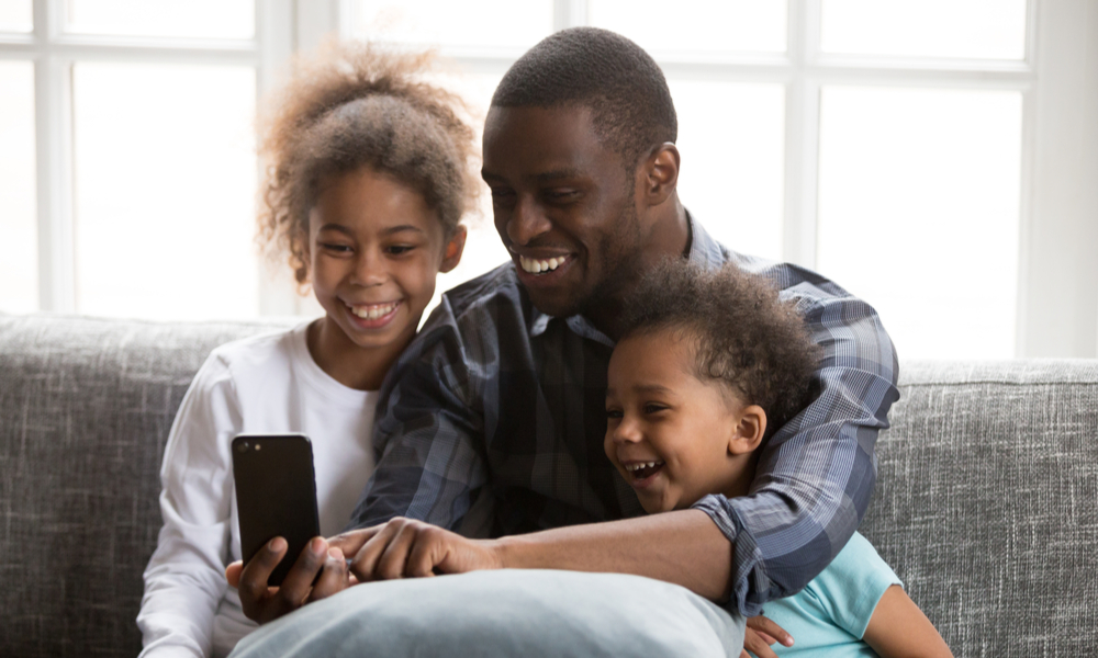 Father taking selfie with two children