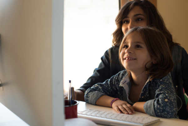 mom and daughter looking on computer