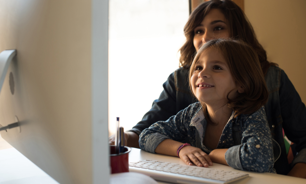 mom and daughter looking on computer