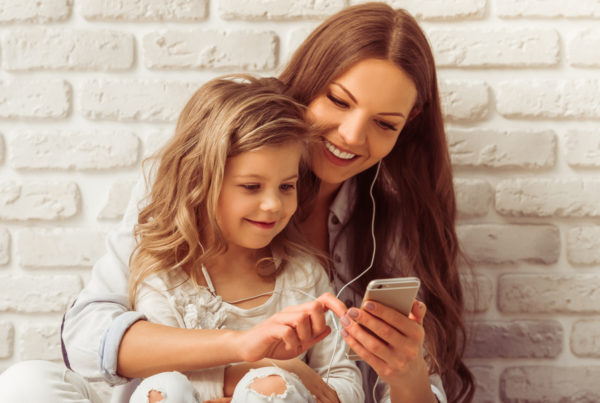 mother and daughter looking at phone
