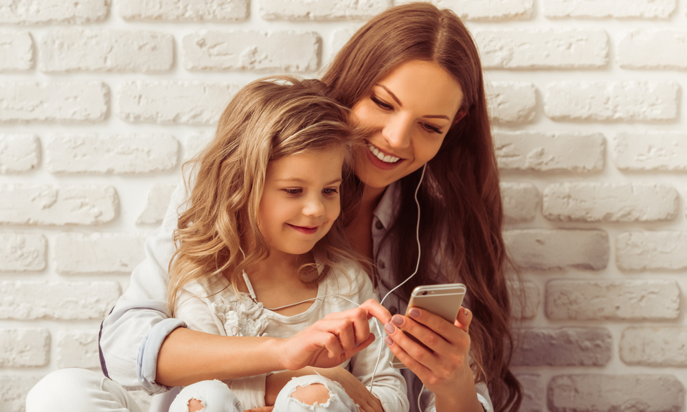 mother and daughter looking at phone