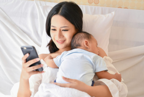 Mother with baby on phone