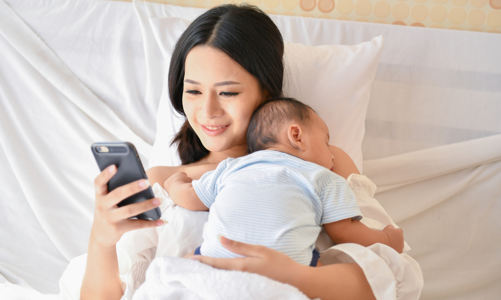 Mother with baby on phone