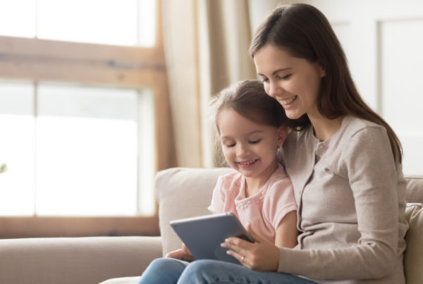 Mother with daughter on tablet