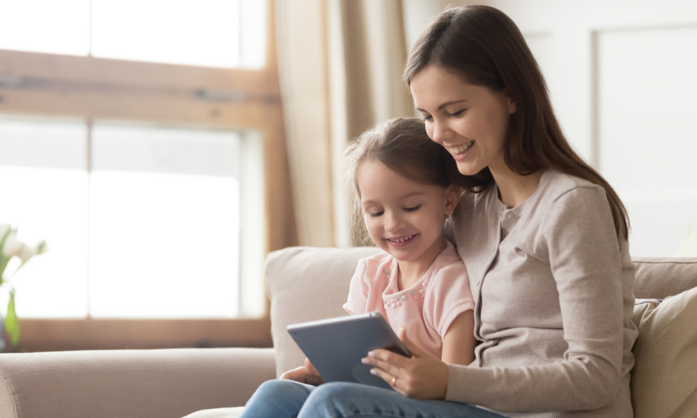 Mother with daughter on tablet