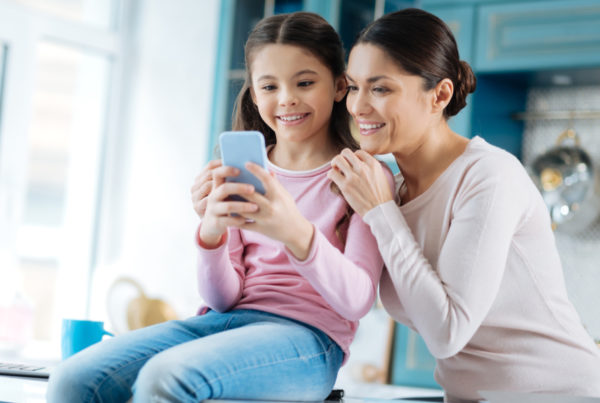 mother and daughter looking at phone