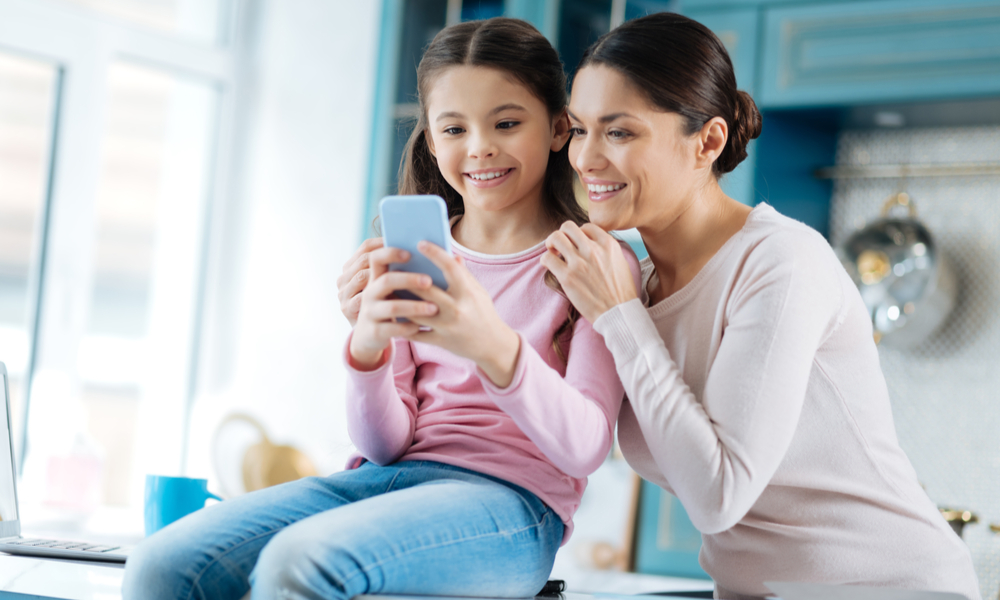 mother and daughter looking at phone